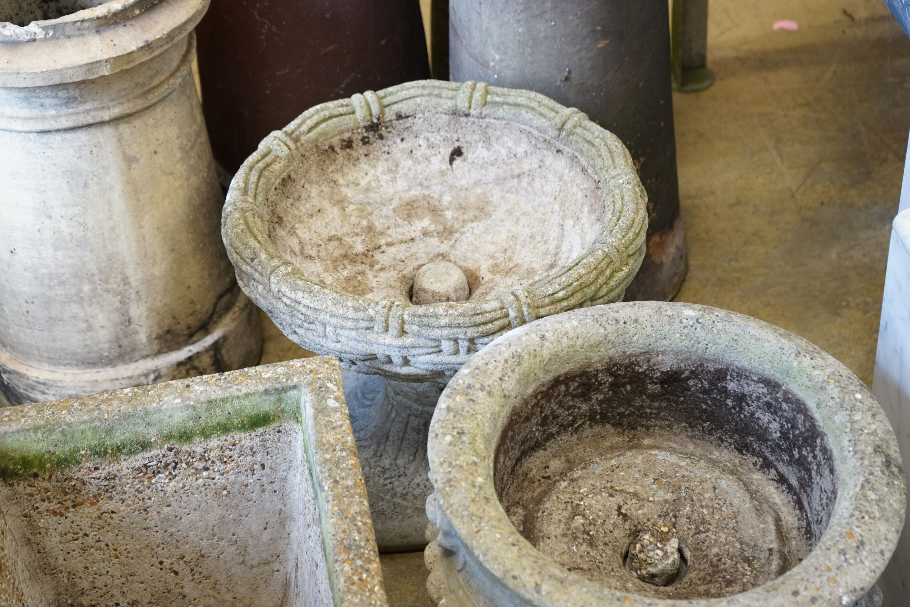 A group of three reconstituted stone garden planters, largest diameter 40cm, height 36cm